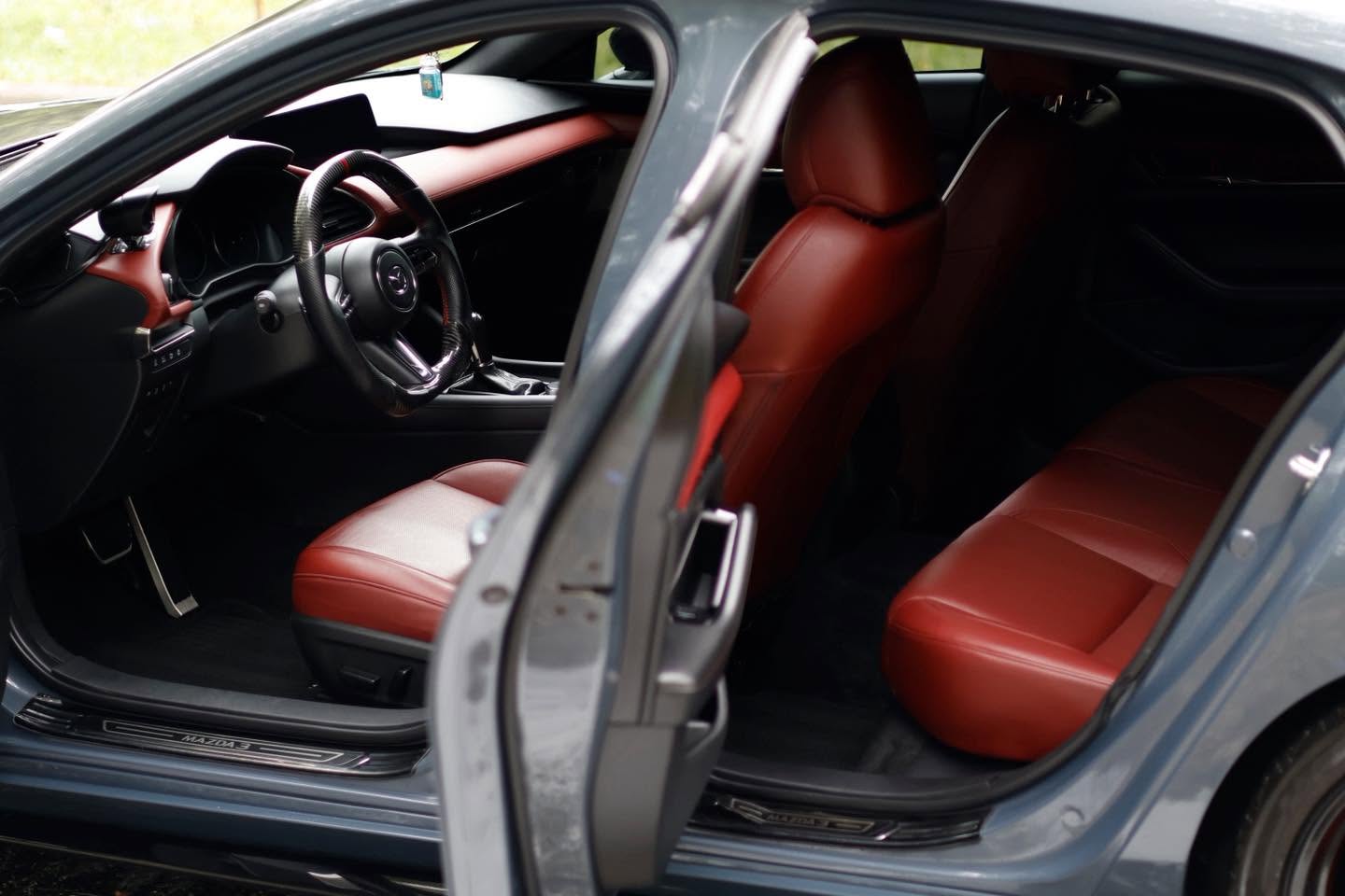 Mazda 3 driver seat with red leather after an interior car detailing