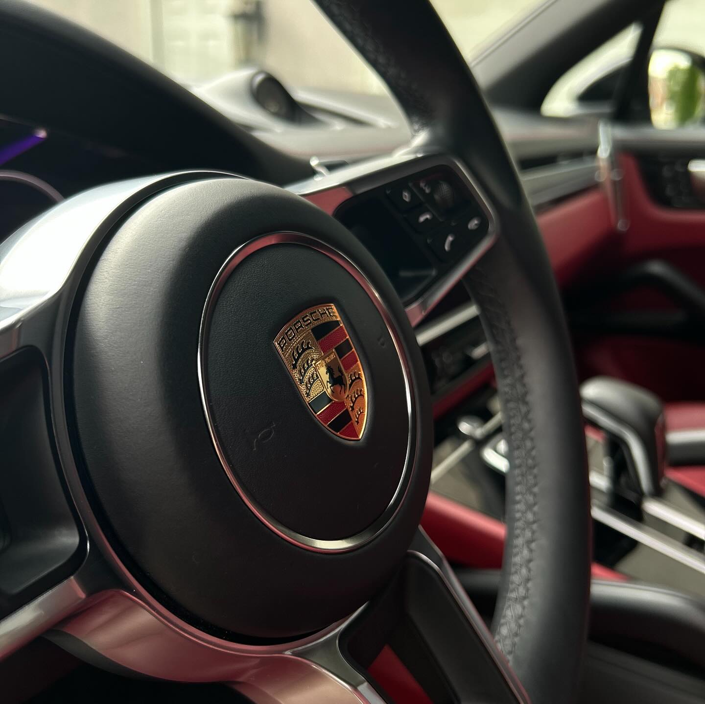 Porsche steering wheel and red interior after auto detailing